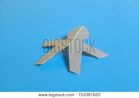 Silver paper man symbol on blue background