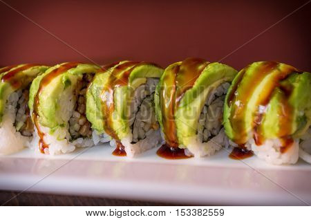 Eel avacado dragon roll with sushi bbq sauce
