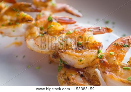 Fresh hot grilled jumbo shrimp kebabs with parsley