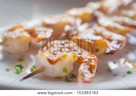 Fresh hot grilled jumbo shrimp kebabs with parsley