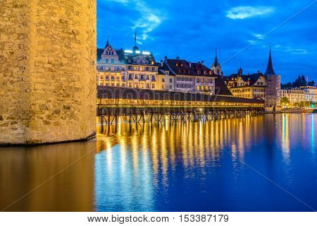 Night view towards Chapel Bridge (Kapellbruecke) together with the octagonal tall tower (Wasserturm) it is one of the Lucerne's most famous tourists attraction