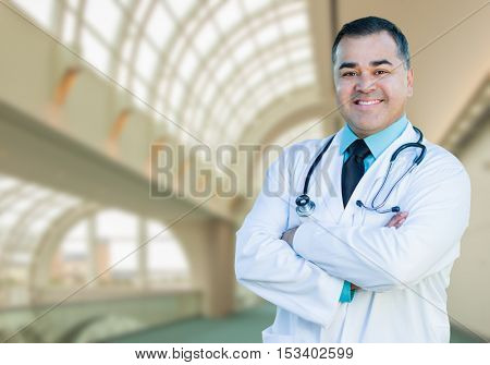 Handsome Hispanic Male Doctor or Nurse Standing Inside Hospital Building.
