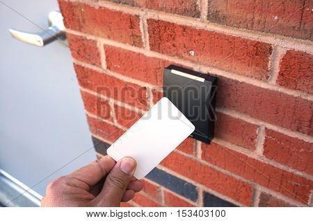 using white entrance card at door entrance card reader