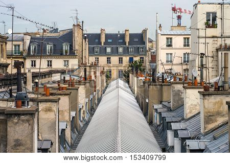 View Of The Upper Floors And The Roof Of A Residential Building In Paris On Blue Sky Background.
