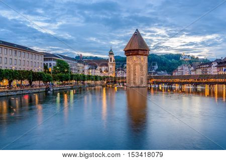 Night view towards Chapel Bridge (Kapellbruecke) together with the octagonal tall tower (Wasserturm) it is one of the Lucerne's most famous tourists attraction