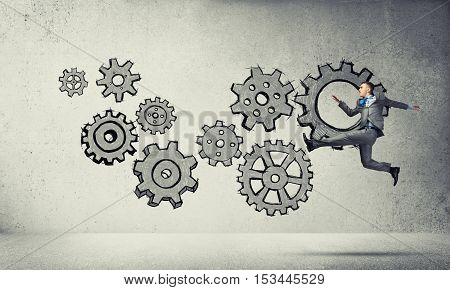 Running businessman on background of business plan sketches
