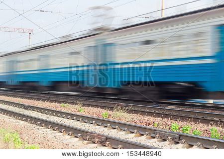 Several blue carriages of fast moving electric multiple unit blurred in motion