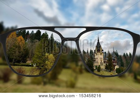 Clear image in glasses against blurry landscape