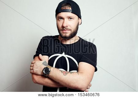 Baerded man in black t-shirt on grey background