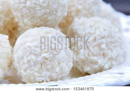 Plate with coconut cookies on table closeup