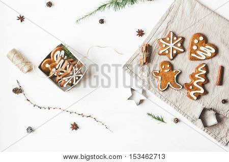 Christmas composition. Gift larch branches cinnamon sticks anise star christmas cookies. Flat lay top view
