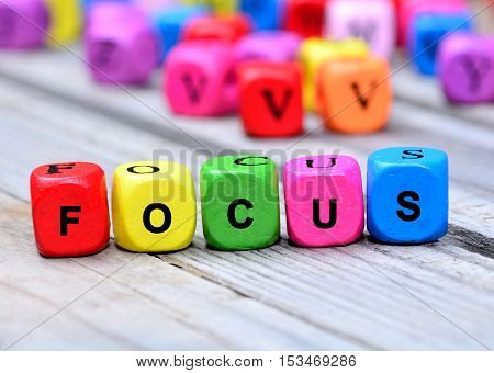Focus word on gray wooden table closeup