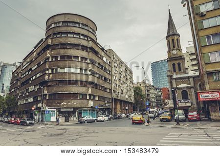 Bucharest Romania - April 22 2014: View of the corner of Stirbei Voda and Luterana streets intersection with interwar building on the left side and the Lutheran Church on the right side.