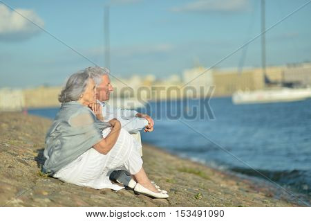 Happy nice mature couple looking at town