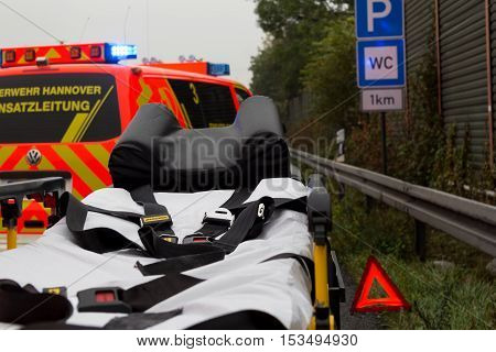 HANNOVER / GERMANY - OCTOBER 25 2016: Emergency stretcher stands with a german firefighting truck on freeway a2 by a truck crash near Hannover.
