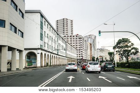 A Coruna Spain - May 28 2016: Cars on main road in the city center of La Coruna on a rainy day