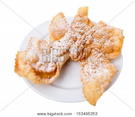 Sweet fried puff biscuits covered with sugar powder. Isolated on a white background.