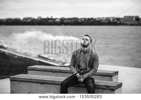 Men With Beard Smoking Electronic Cigarette Outdoor
