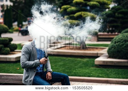Men With Beard Vaping Electronic Cigarette Outdoor