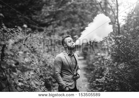 Men With Beard Smoking Electronic Cigarette Outdoor