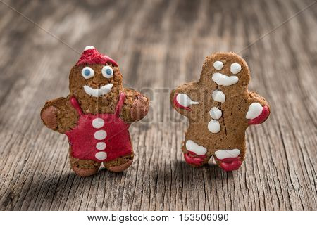 Two Decorated Gingerman Cookies On Rustic Wooden Background