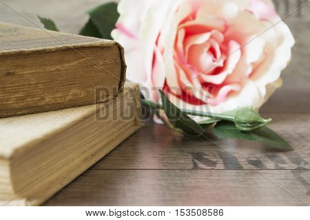 Old Books And Flower Rose On A Wooden Background. Romantic Floral Frame Background. Picture Of A Flo