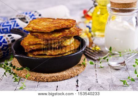 Traditional potato pancakes with sour cream. Selective focus.