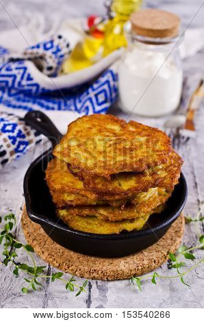 Traditional potato pancakes with sour cream. Selective focus.