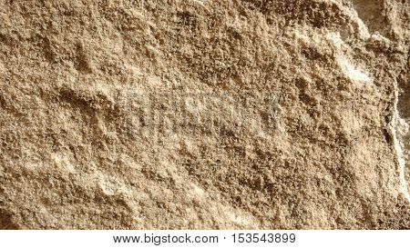 An old uneven stone wall texture closeup