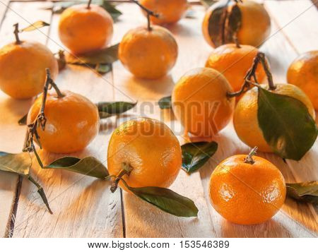 Beautiful juicy sweet orange tangerines lie on the wooden table