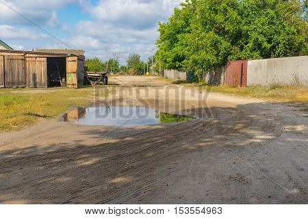 Sandy road on a street of small village at fall season Sumskaya oblast Ukraine
