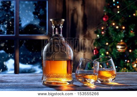 close up view  of two glasses with whiskey on color back