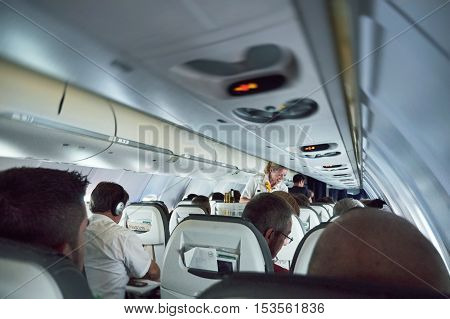 GERMANY - JUN 7 2015: Lufthansa Airlines plane full with passengers with smiling stewardess serving travelers