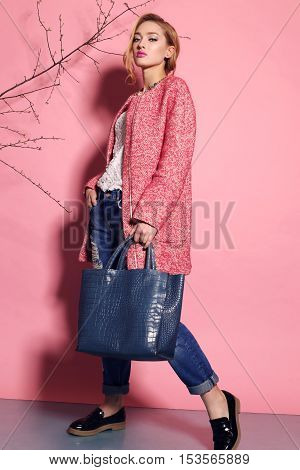 fashion studio photo of gorgeous young woman with blond hair in elegant clothes with acccessories
