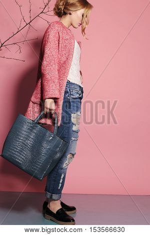fashion studio photo of gorgeous young woman with blond hair in elegant clothes with acccessories