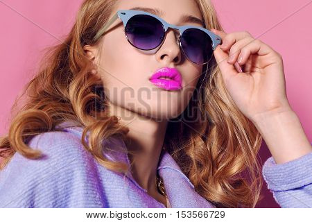 fashion studio photo of gorgeous young woman with blond hair in elegant clothes with acccessories