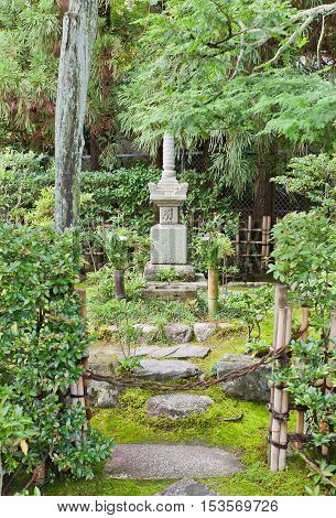 UJI JAPAN - JULY 27 2016: Grave of samurai Minamoto Yorimasa on grounds of Byodo-in Temple in Uji city near Kyoto. Yorimasa (1106-1180) committed suicide at Byodo-in after defeat in Battle of Uji
