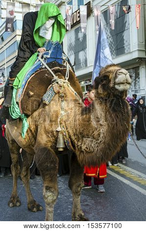 Istanbul Turkey - October 11 2016: Representation on the camels to revive Karbala in the seventh century takes part in an Ashura parade. Turkish Shia Muslims mourning for Imam Hussain. Caferis take part in a mourning procession marking the day of Ashura i