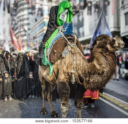 Istanbul Turkey - October 11 2016: Representation on the camels to revive Karbala in the seventh century takes part in an Ashura parade. Turkish Shia Muslims mourning for Imam Hussain. Caferis take part in a mourning procession marking the day of Ashura i