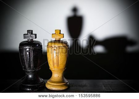shadows of king pieces with one lying down