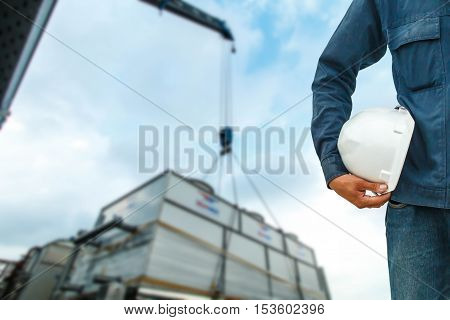 The engineering and safety helmets stood on the details of Industrial Crane operating and lifting
