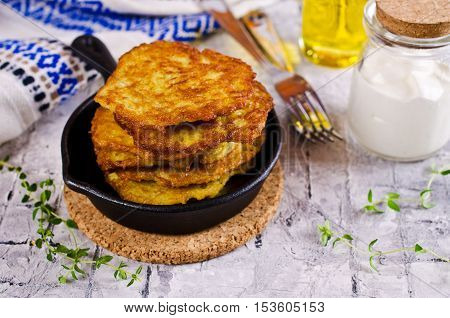 Traditional potato pancakes with sour cream. Selective focus.