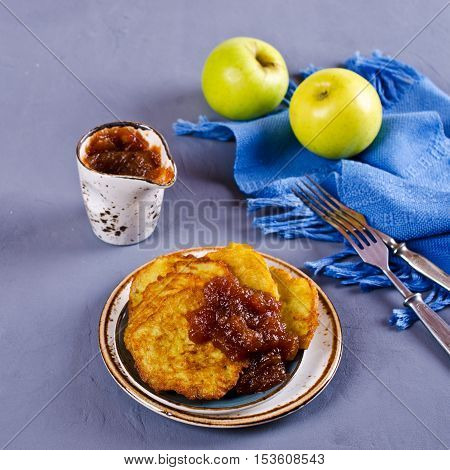 Traditional potato pancakes with apple jam. Selective focus.