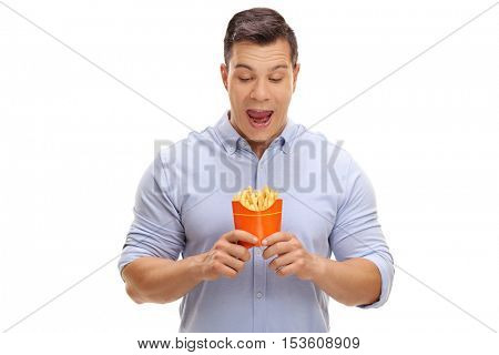 Overjoyed young man looking at a bag of fries isolated on white background