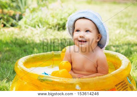Baby Girl In Cotton Panama Cap Bathes In Inflatable Swimming Paddling Pool