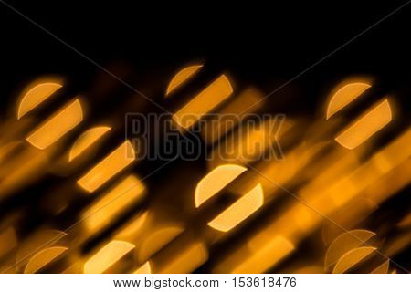 Bokeh dark orange circles and stripes on black background. Abstract music background.