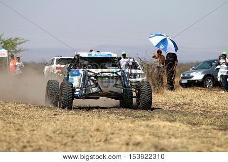 Speeding White Aceco Rally Car Front View