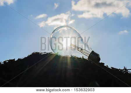 light bulb with sunshine power concept and blue sky background