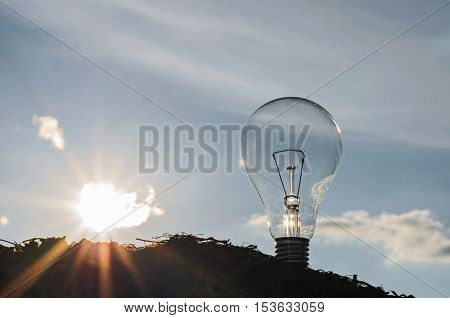 light bulb with sunshine power concept and blue sky background