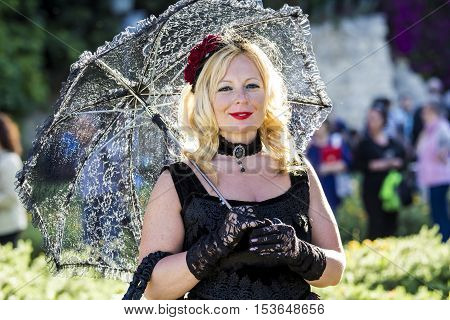 CAGLIARI, ITALY - May 29, 2016: Sunday at La Grande Jatte VIII Ed. At the Public Gardens - Sardinia - portrait of a beautiful woman in Victorian costumes